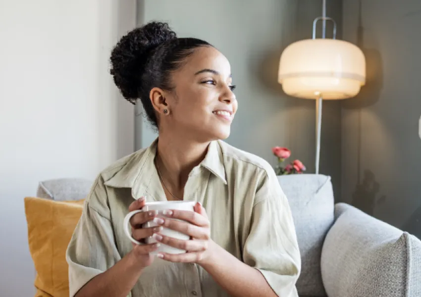 Lady holding a mug and looking away