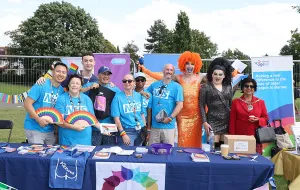 A group photo of the sexual health team at Pride, posing with 2 with drag queens and the Mayor of Barnet