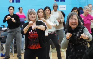 A group of women exercising and smiling together