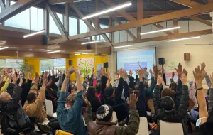 A room full of people doing chair yoga