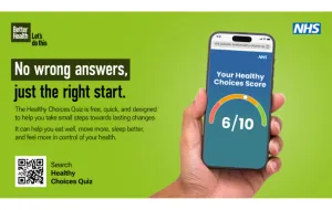 A hand, holding a mobile phone.
