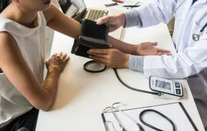 A doctor taking someone's blood pressure reading.