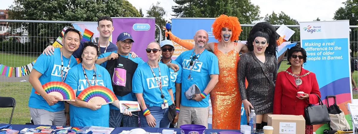 A group photo of the sexual health team at Pride, posing with 2 with drag queens and the Mayor of Barnet