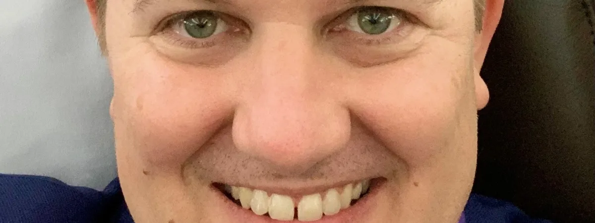 Photo of Adam smiling