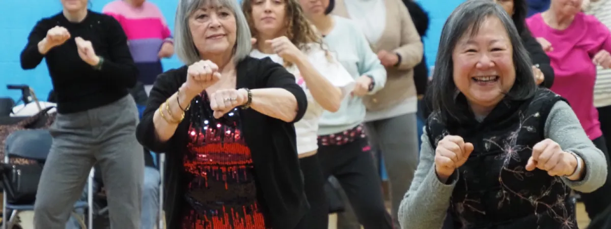 A group of women exercising and smiling together