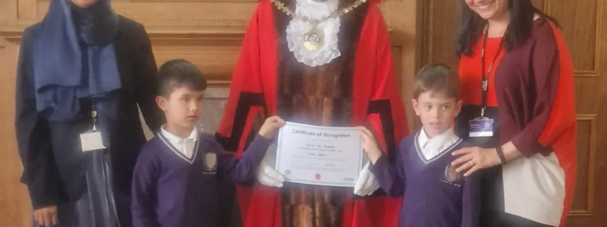 Pupils and staff receiving award from the Mayor of Barnet