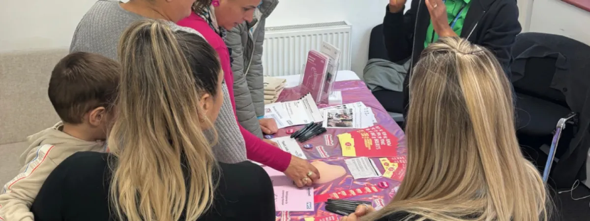 Picture of a female speaking & raising cancer awareness to a group of females.