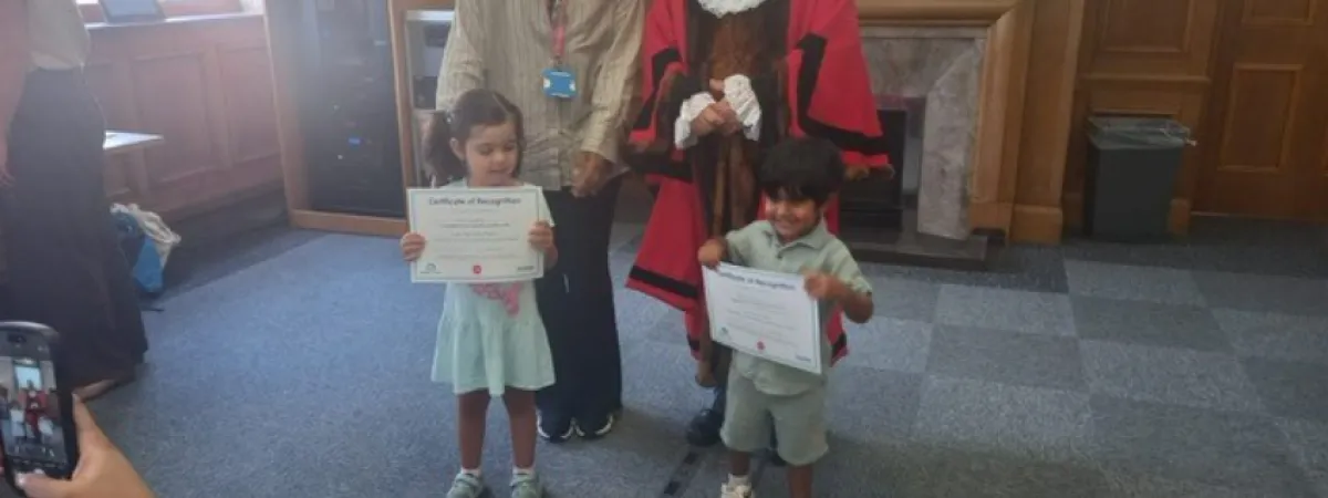 The mayor awarding even more certificates to children