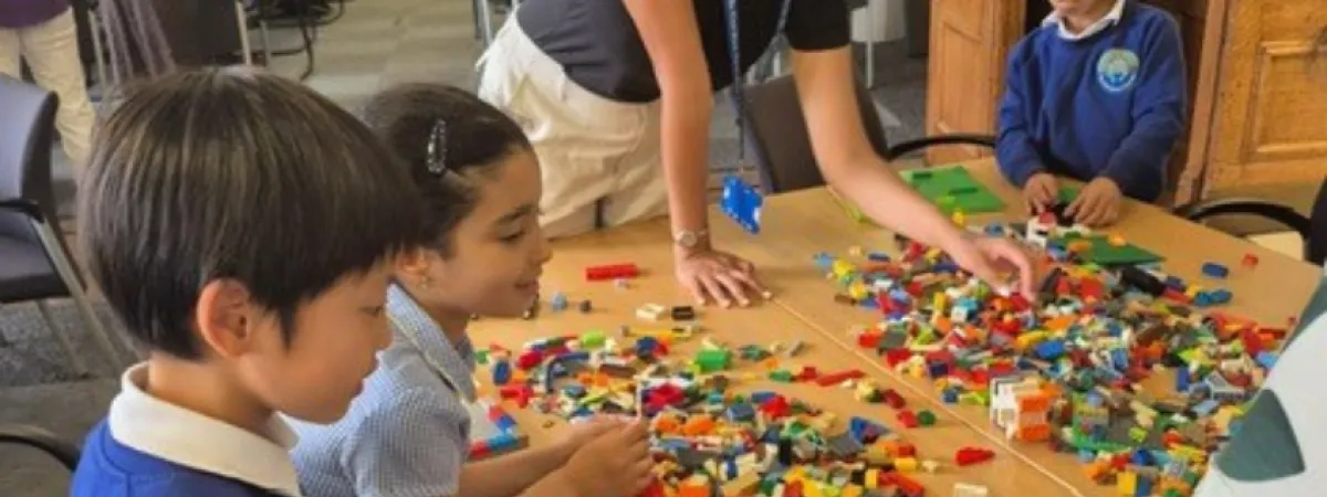 Children being distracted with lego bricks on a table