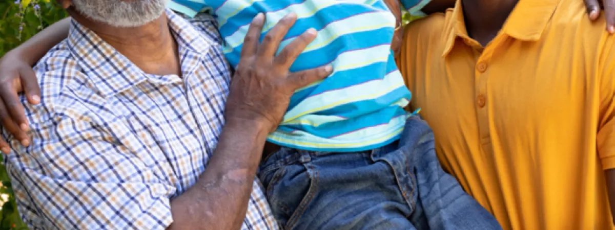 Family holding son in arms.