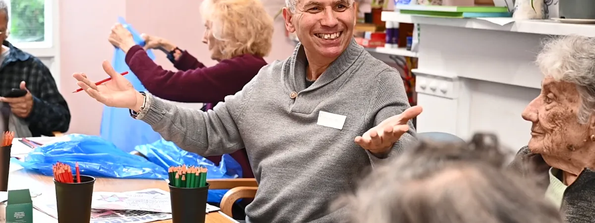 Man sitting in a chair smiling.