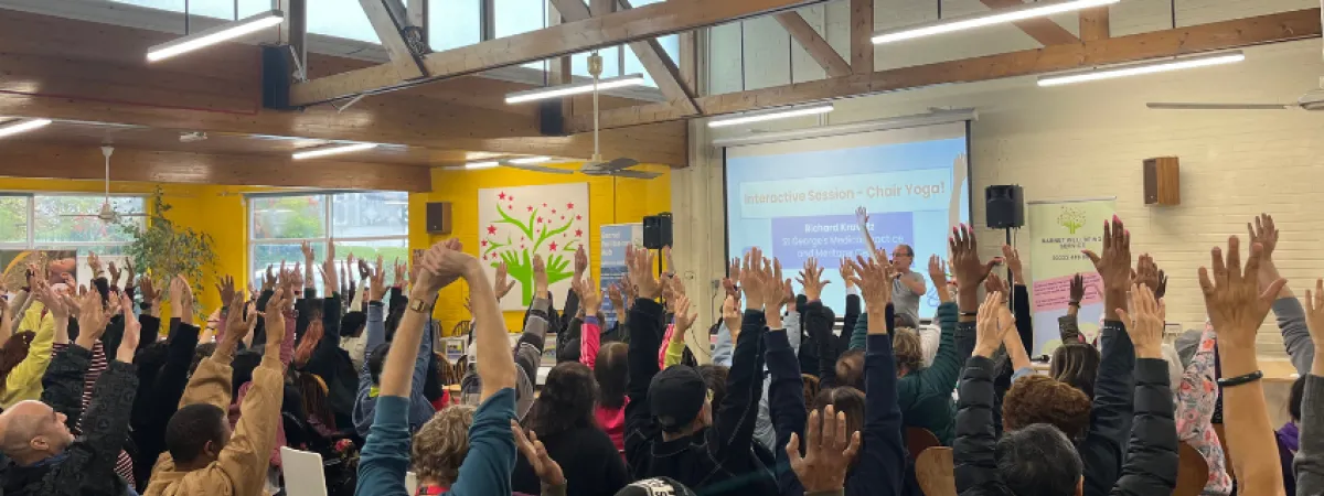 A room full of people doing chair yoga