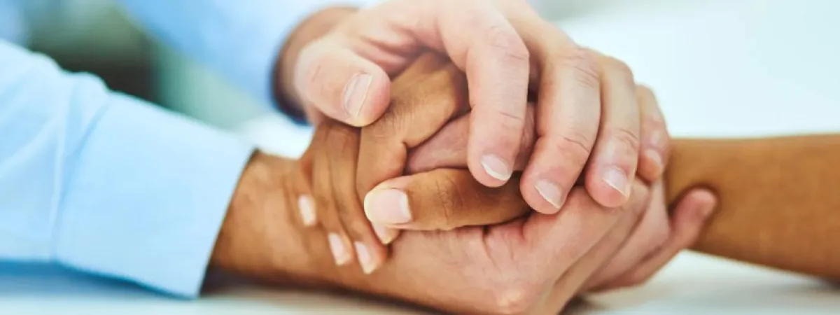 Somebody holding someone else's hand in their hands.