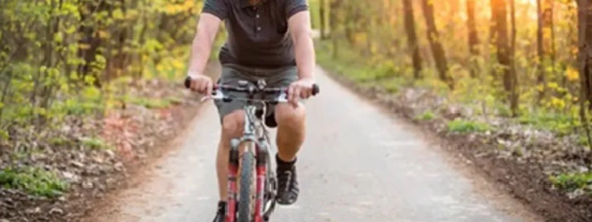 A man enjoying a bike ride in the woods