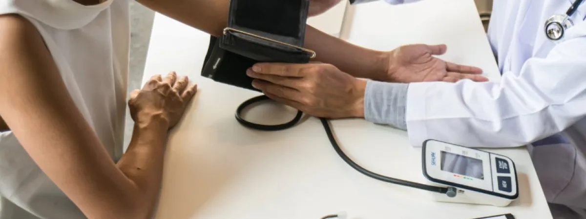 A doctor taking someone's blood pressure reading.
