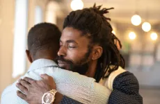 Two men hugging